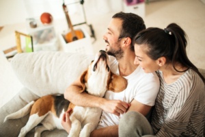 Couple and dog in Clackamas, Oregon, enjoying their home after furnace repair services from Central Air