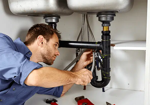Plumber doing emergency repairs in Portland home
