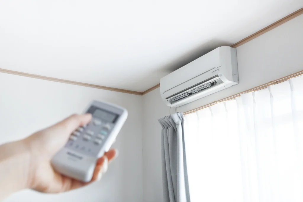 Technician turning on a ductless mini-split in Portland home.