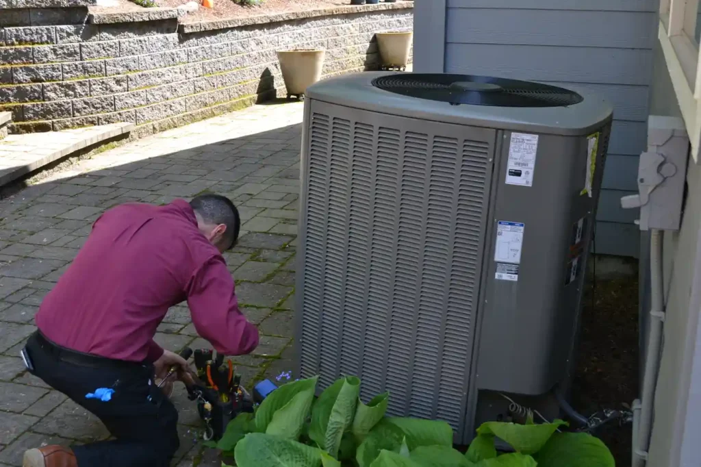 Technician repairing a refrigerant leak in Portland home.
