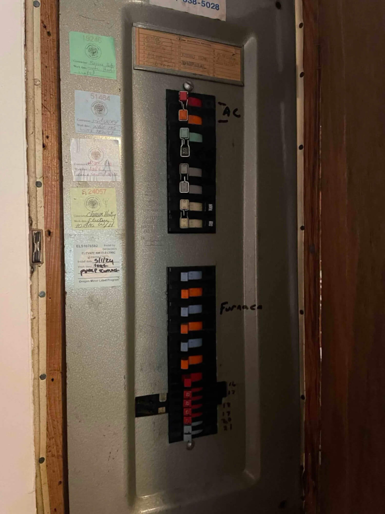 HVAC technician inspecting an outdoor air conditioner condenser after a circuit breaker kept tripping at a Portland, Oregon home