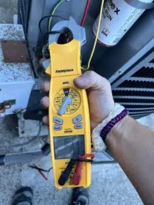 Technician diagnosing a commercial arcade cooling unit in Clackamas OR.