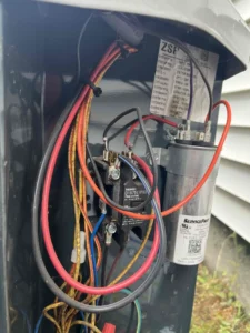 Technician replacing a failing AC fan motor at a Portland home.